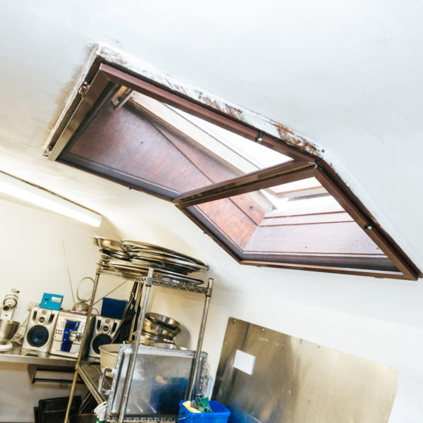 A brown fly screen installed in a ceiling of a kitchen