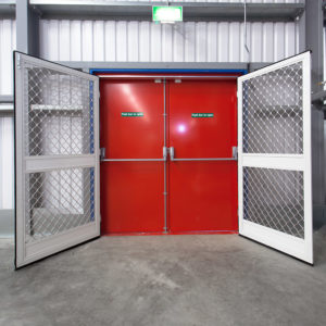 Two heavy duty fly screen doors next to a red emergency door
