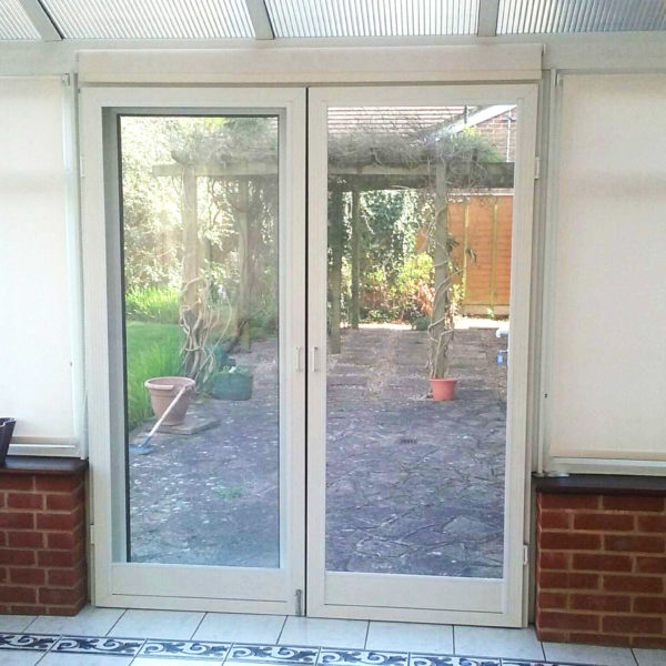 Two standard fly screen doors on conservatory doors