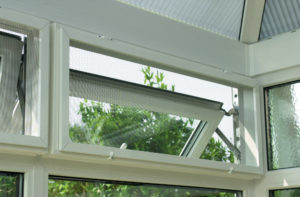 A white screen and sub frame on a window in a conservatory