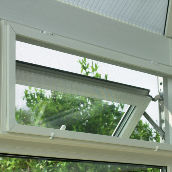 A white screen and sub frame on a window in a conservatory