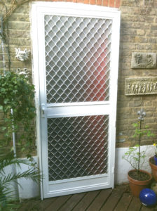A white security fly screen door on a residential door