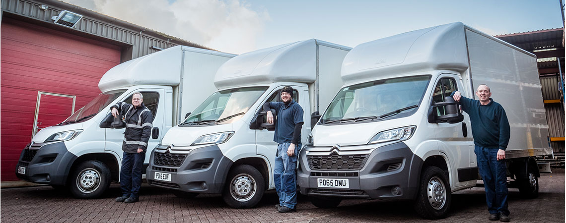 Three vans with their technicians prepared for an installation