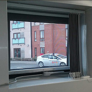White flexicon screen installed to window in office with blinds in the way