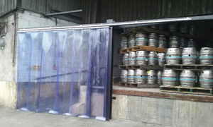 Sliding pvc curtain installed next to beer kegs