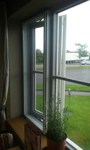 White fly screen installed to a window in domestic property lounge