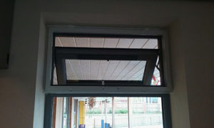 White fly screen installed to top half of a window