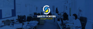 shot of office with workers all sat at screens working with safety screens logo on