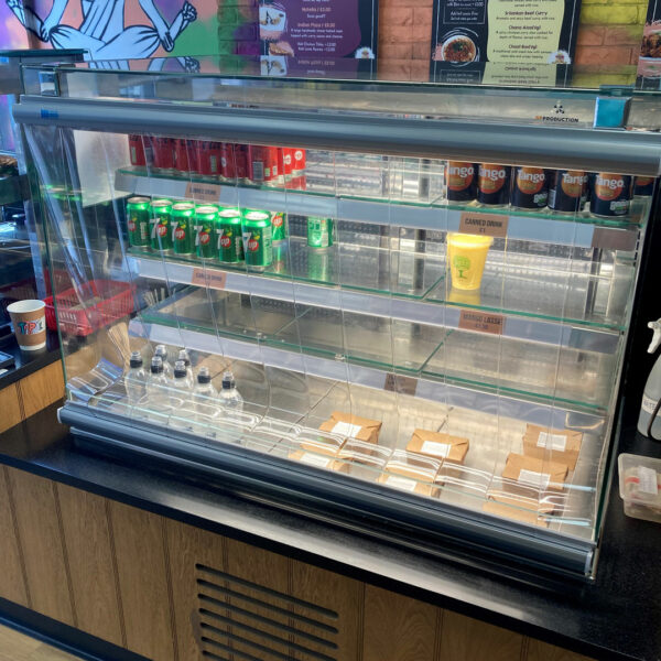 Counter filled with canned and bottle drinks behind pvc strips
