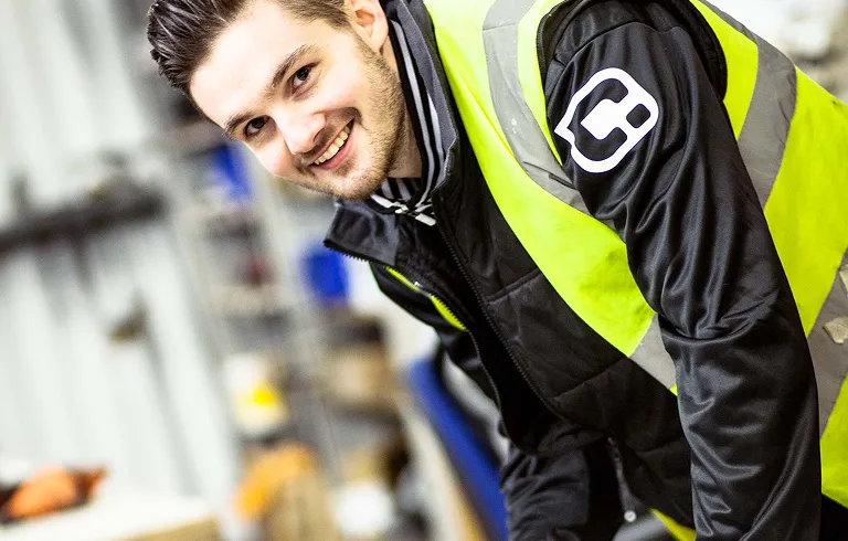 Smiling worker wearing a high visibility vest